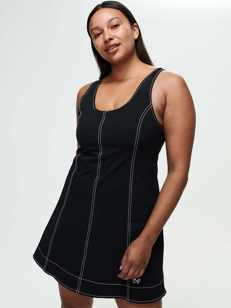 Model showcasing the Energy Dress, featuring A-line silhouette and contrast topstitching in breathable LightSpeed fabric.