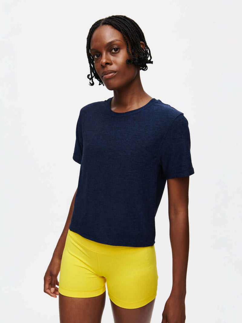 Model wearing the CloudKnit Boxy Shortsleeve paired with yellow shorts, showcasing a stylish and comfortable look.