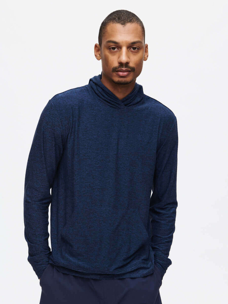 Model wearing a stylish navy CloudKnit Hoodie, featuring a cozy design and breathable fabric for comfort.