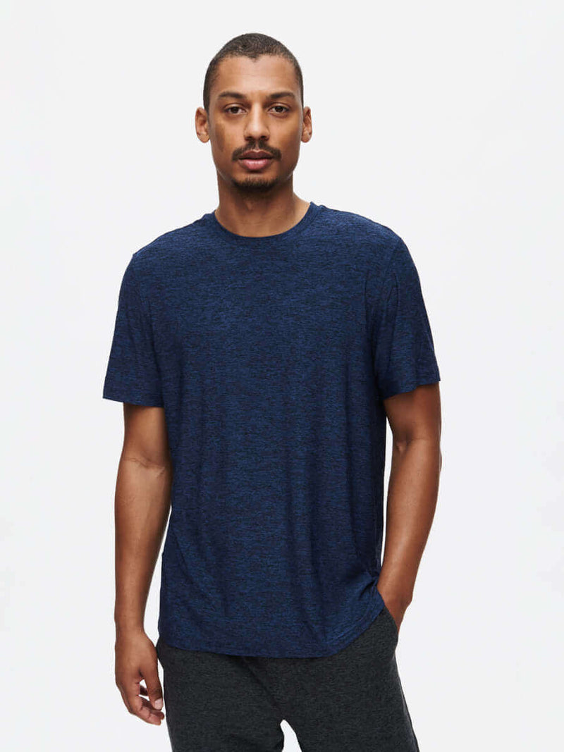 Model wearing CloudKnit Shortsleeve t-shirt in navy blue, showcasing its soft and lightweight fabric for everyday comfort.