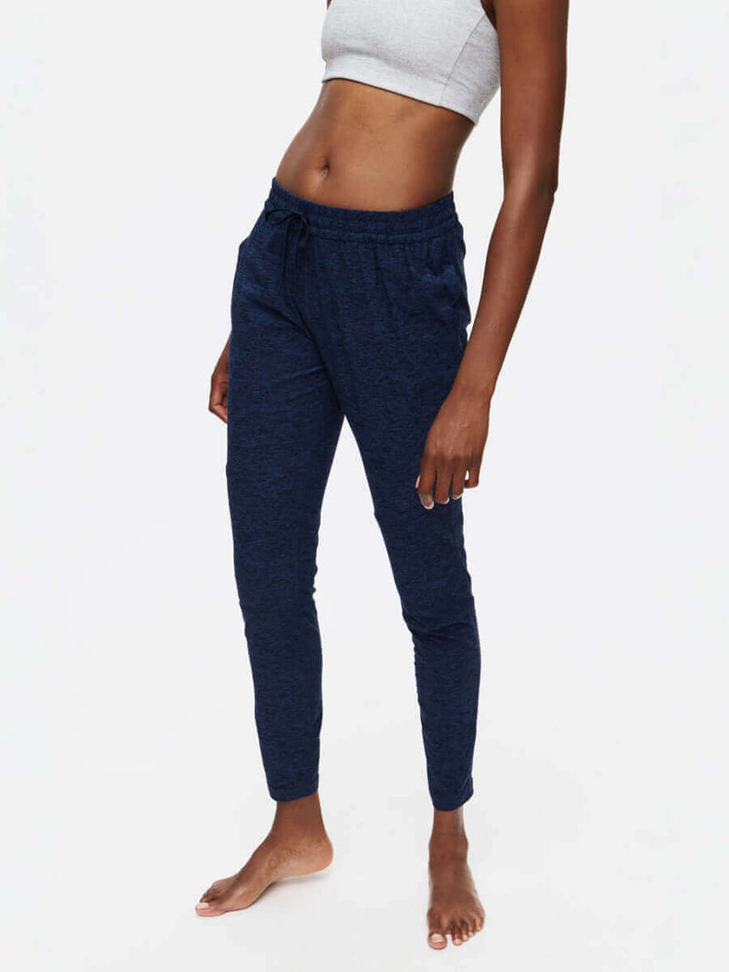 Model wearing CloudKnit Sweatpant, showcasing mid-rise fit, side pockets, and drawstring waistband in navy.
