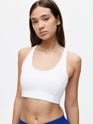 Model wearing the Doing Things Bra CL in white, showcasing comfort and style for activewear.