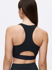 Back view of the Doing Things Bra showcasing the mesh backing and Outdoor Voices logo on the elastic band.