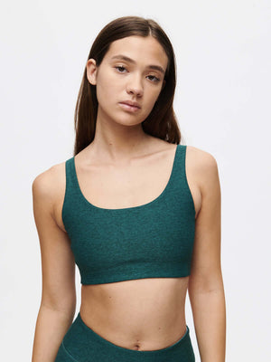 Model wearing a stylish Double Time Bra CL in green, showcasing comfort and elegance.