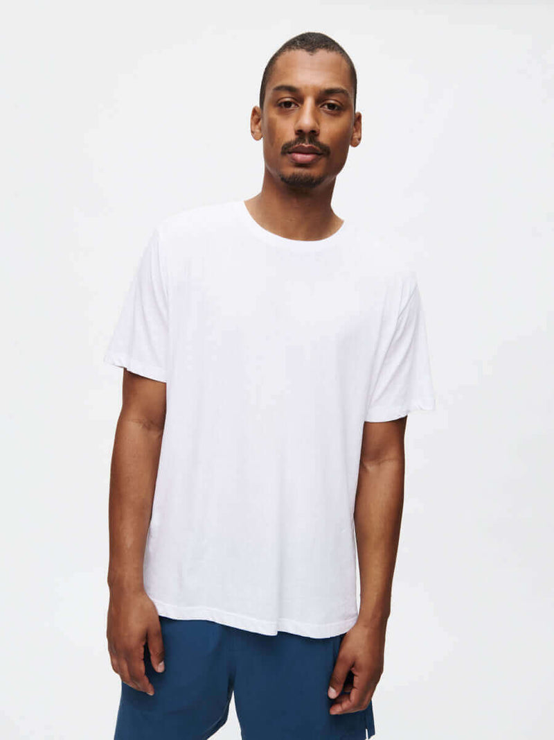 Man wearing an Everyday Classic Shortsleeve t-shirt in white, showcasing its soft and breathable organic cotton jersey.
