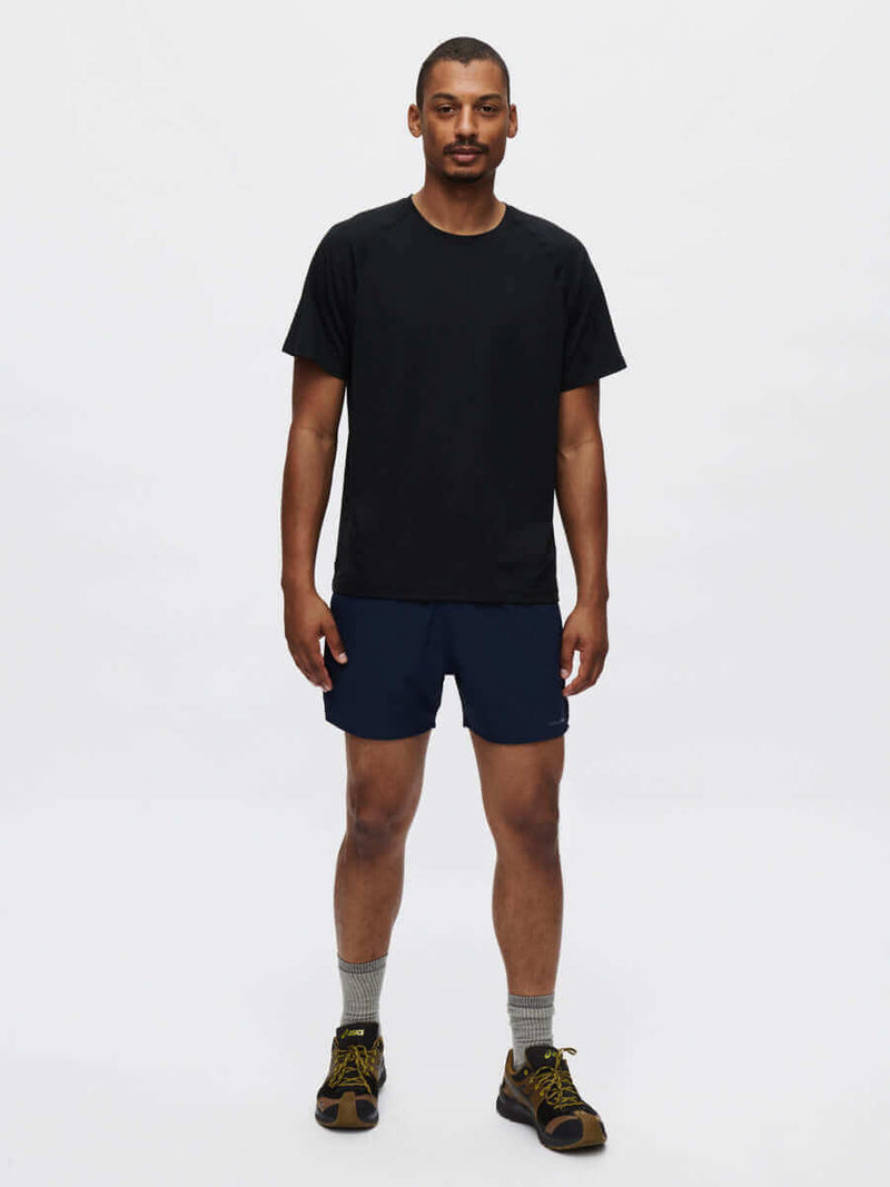 High Stride 5" Short with Pockets worn by a man in training outfit, featuring front pockets and a lightweight design.