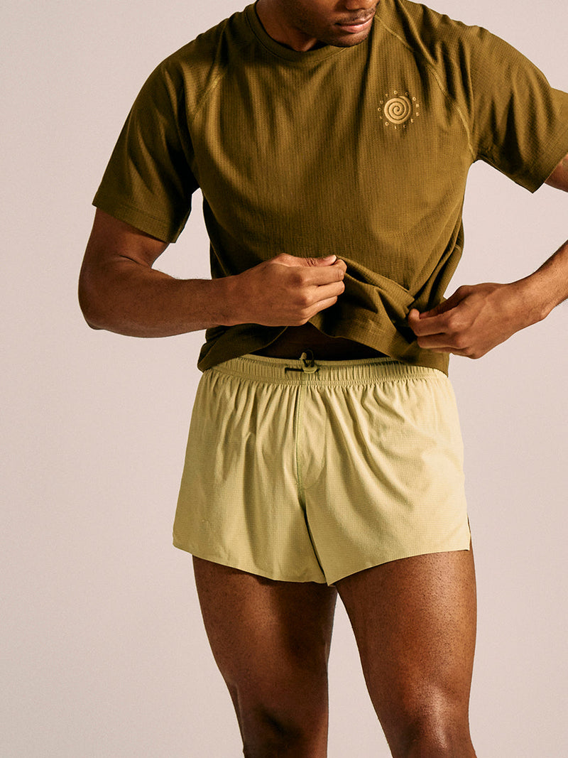 a person wearing a green shirt and light green shorts