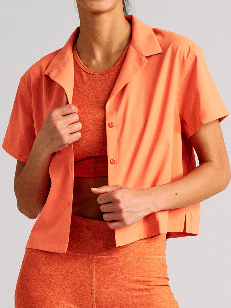 a person wearing an orange shirt with orange shorts