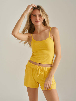 Model wearing the CloudKnit Cami CL in vibrant yellow, showcasing its soft style and perfect fit.