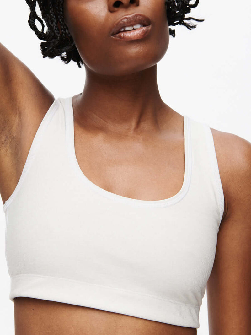 Medium-impact Orbit Bra with soft-fit elastic band and OV logo, showcasing textured compression fabric and stylish contrast stitching.