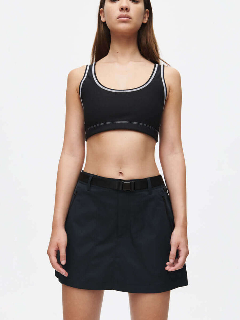 Outdoor 4" Skort paired with a stylish black crop top, showcasing a sporty yet trendy look.