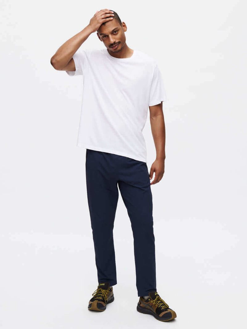 Model wearing RecTrek Pant with a white t-shirt, looking relaxed and ready for adventure.