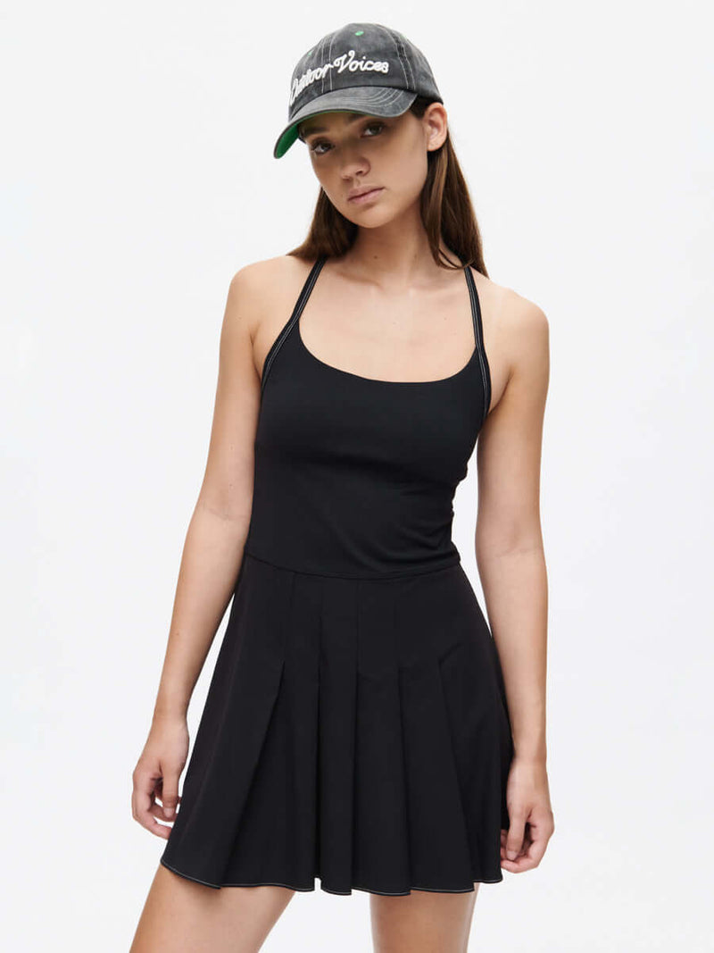 Sporty Dress featuring adjustable straps and a built-in bra, styled with a trendy cap.