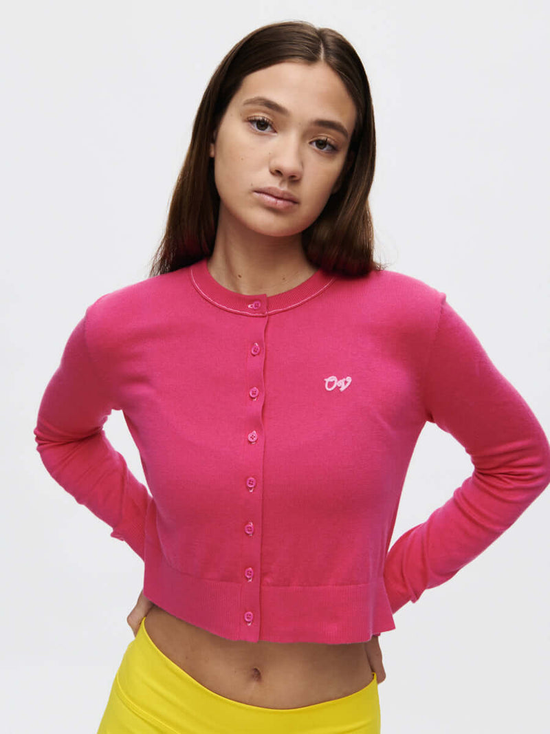 Sugar Cardigan in hot pink, featuring buttons and hand-embroidered OV signature for a stylish lightweight look.