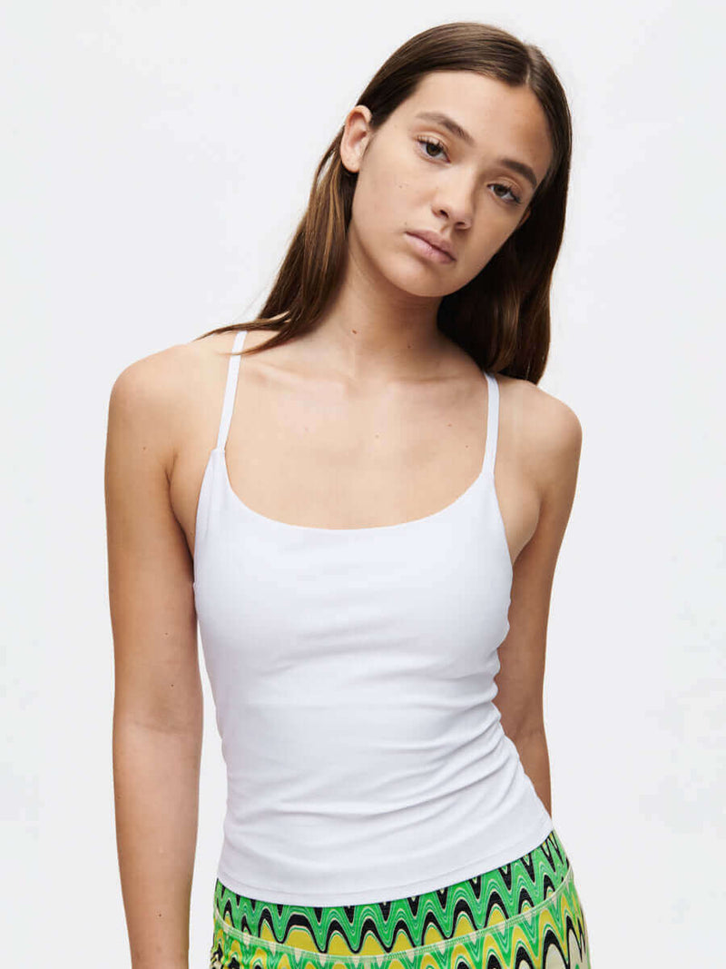 Model showcasing the TechSweat Move Free Tank, a high-performance sports top with adjustable straps.
