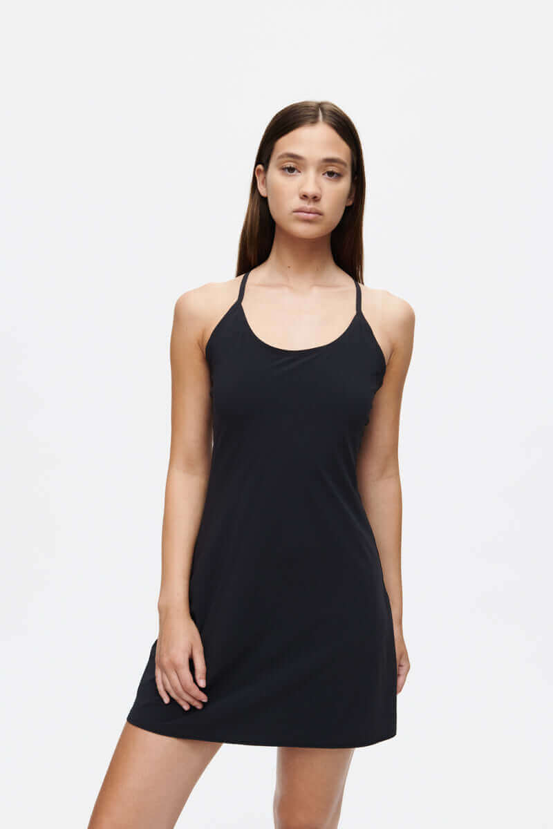 The Exercise Dress worn by a model, featuring adjustable straps and a sporty, flattering fit for active lifestyles.