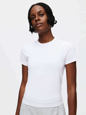 A model wearing a ThinkFast Jersey Baby Tee, showcasing its soft and breathable jersey fabric for active fun.