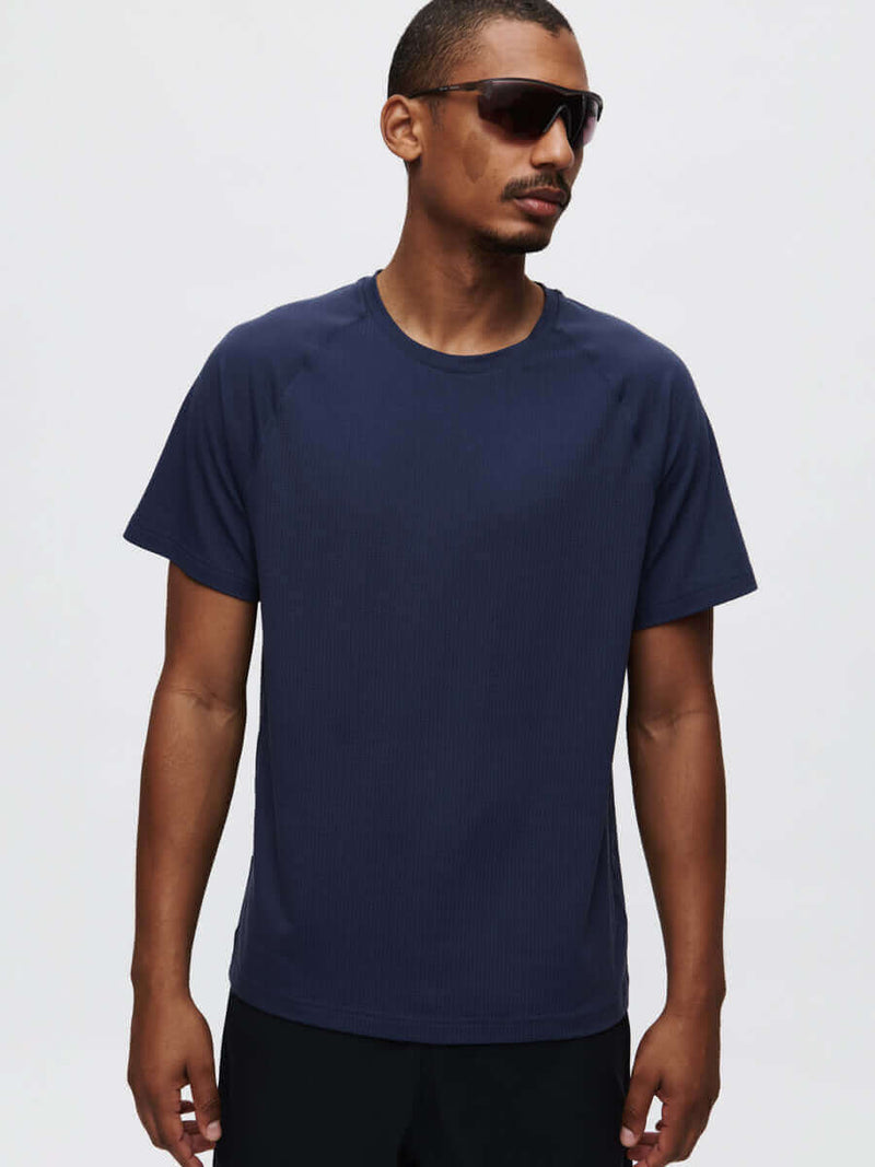 Model wearing ThinkFast Mesh Shortsleeve t-shirt, showcasing its classic fit and cooling technology.