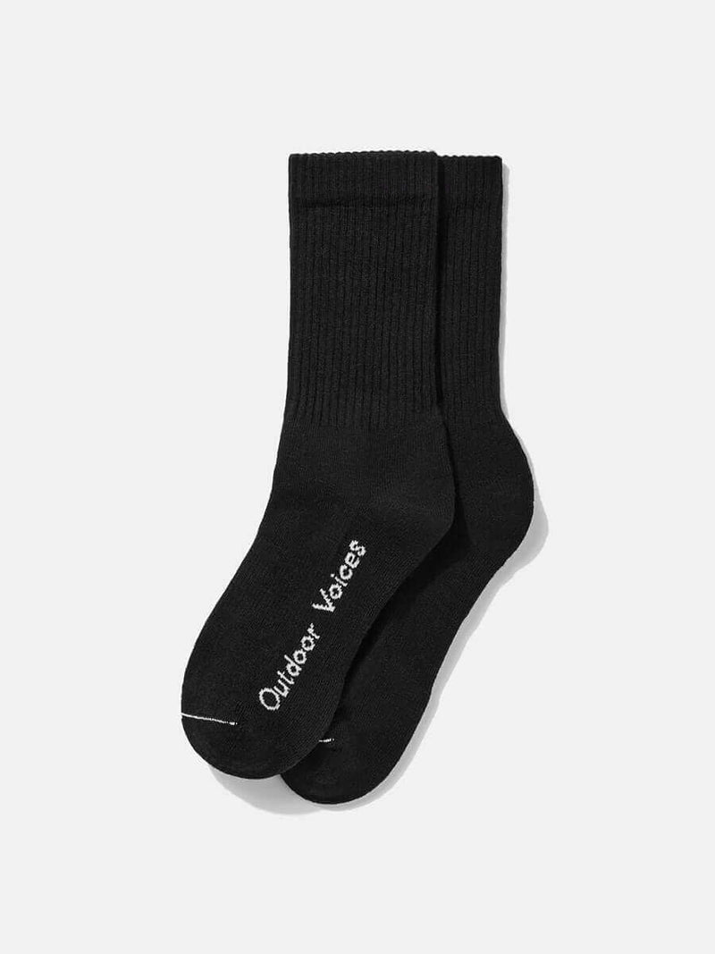 OV Solid Crew Sock in black, featuring the Outdoor Voices logo, perfect for sports and daily wear.
