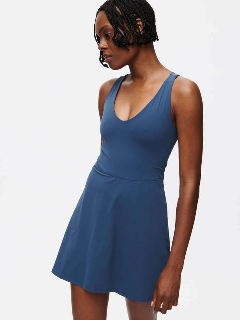 Volley Dress in a deep blue color featuring a V-neck and fit-and-flare silhouette.