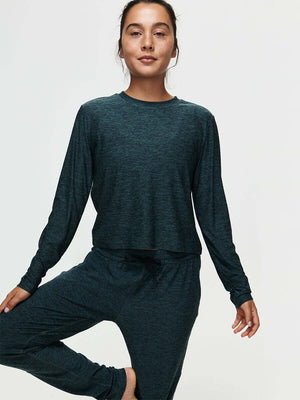 Lifestyle image of a model wearing the CloudKnit Boxy Longsleeve shirt styled with comfortable pants.