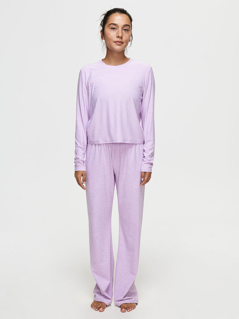 Woman wearing cozy CloudKnit Wide Leg Pant and matching top in soft lavender color, perfect for lounging.