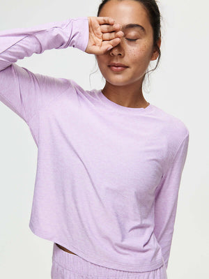 A model wearing the CloudKnit Boxy Longsleeve in soft purple, showcasing its comfort-first design.
