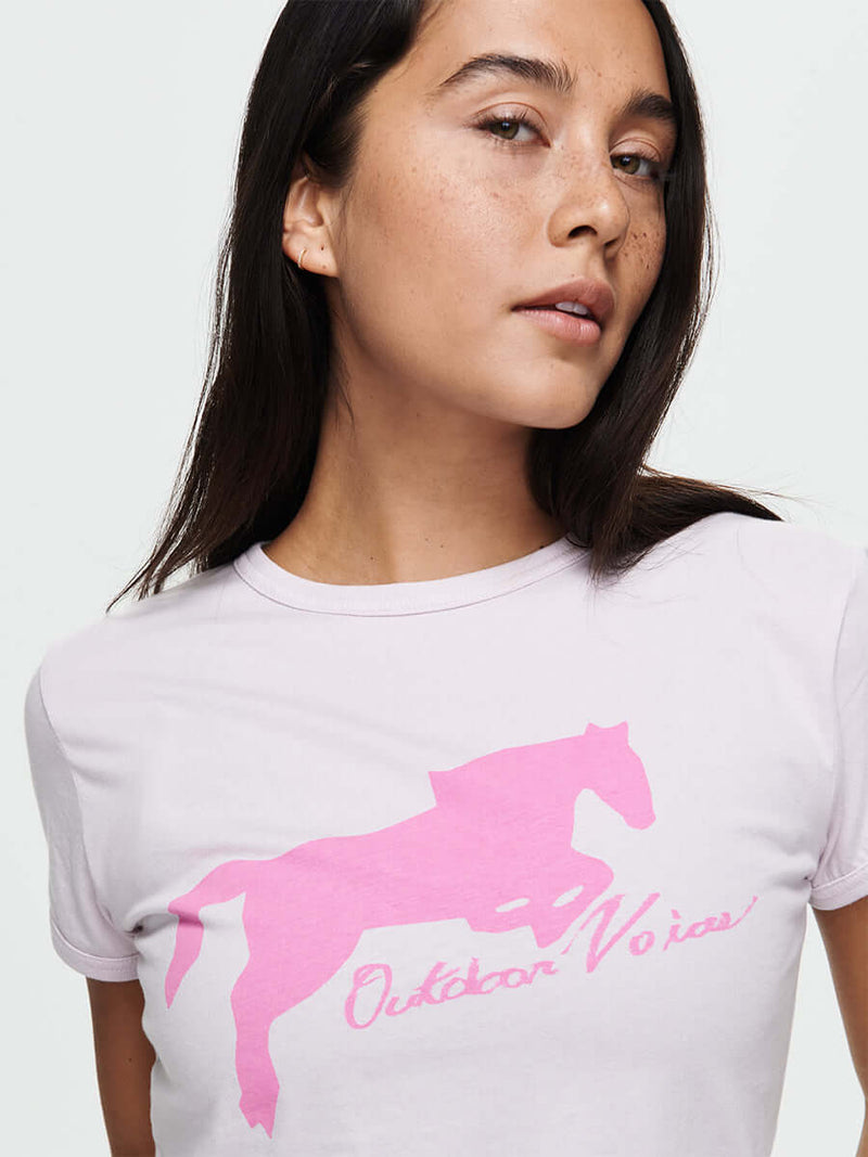 Model wearing lightweight Mustang Tee with untamed pink horse graphic on Orchid Dust background.