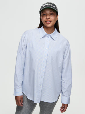 Model wearing a Striped Sun Shirt, showcasing an oversized fit and subtle stripes in lightweight cotton.