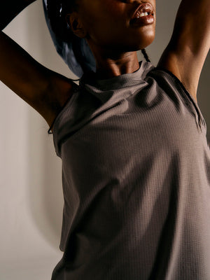 a person wearing a grey tank top