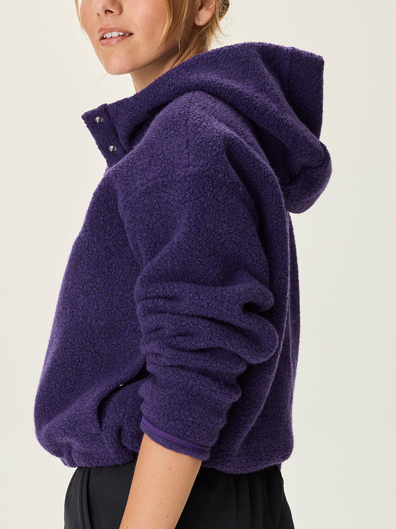 a person wearing a purple sweater