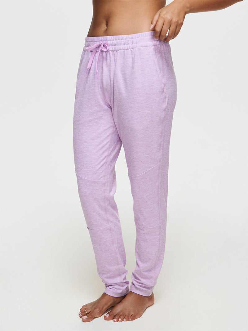 Woman wearing CloudKnit Sweatpant in light pink, showcasing a custom-fit drawstring waistband.
