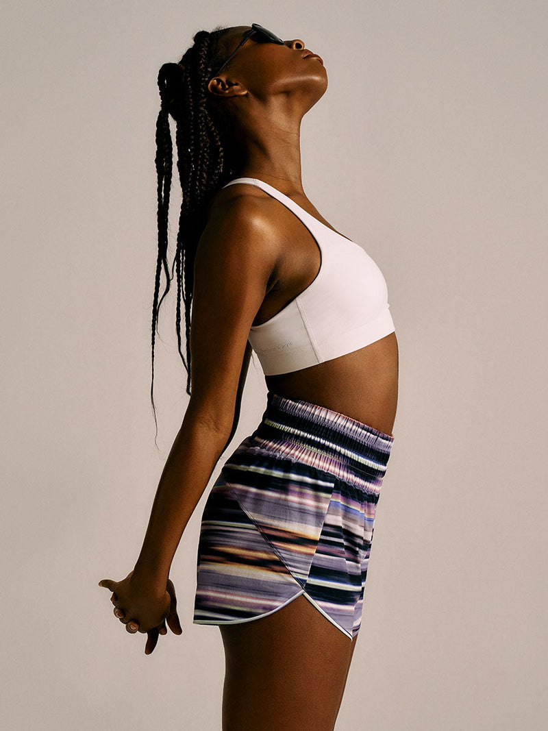 a person wearing purple patterned shorts