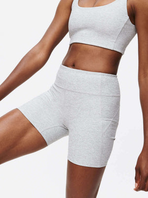 Model wearing Warmup 5" Short in textured compression fabric, perfect for workouts and easy movement.