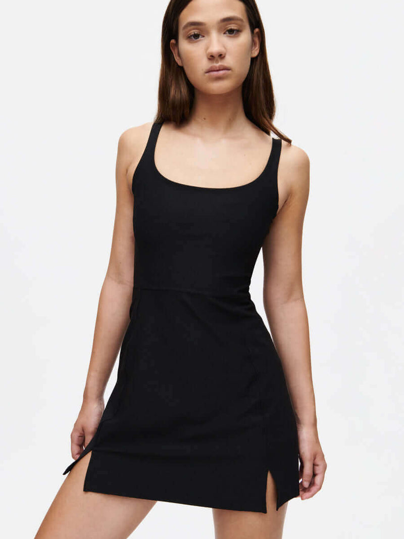 Model showcasing the Warmup Dress with a sleek design in black, perfect for active lifestyles.